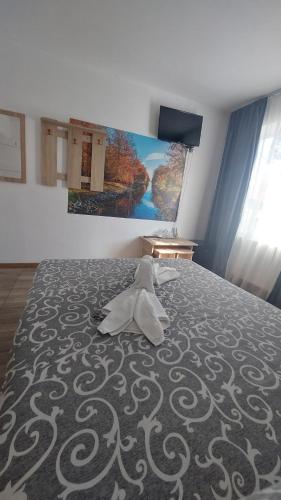 a bedroom with a bed with a white pillow on it at Sîrbu Orsova in Orşova