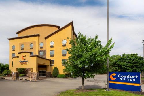 a yellow building with a sign in front of it at Comfort Suites Monroeville - Pittsburgh East in Monroeville