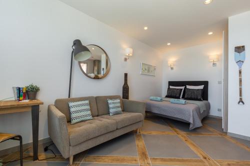 a living room with a couch and a bed at La Maison Du Pêcheur in Cagnes-sur-Mer