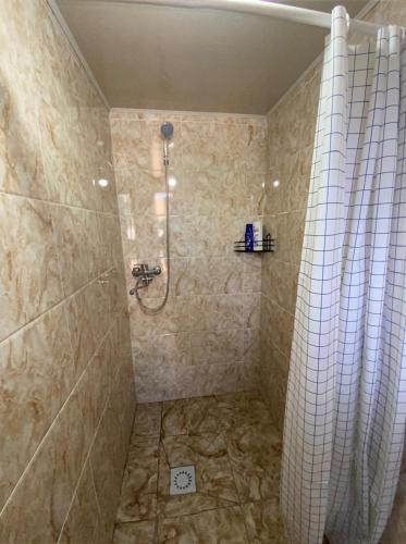 a bathroom with a shower with a shower curtain at Pari Guest House in Kaji-Say