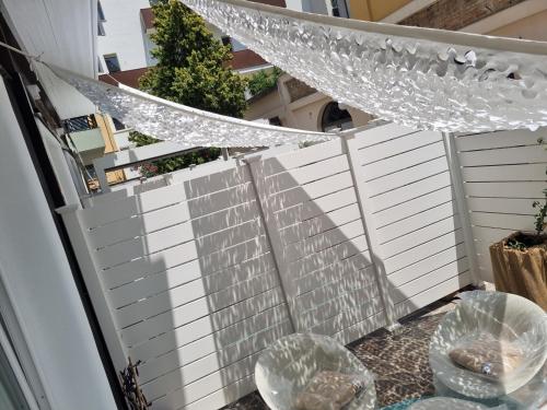 a white fence with glasses on a table at New Pescara City b&b in Pescara