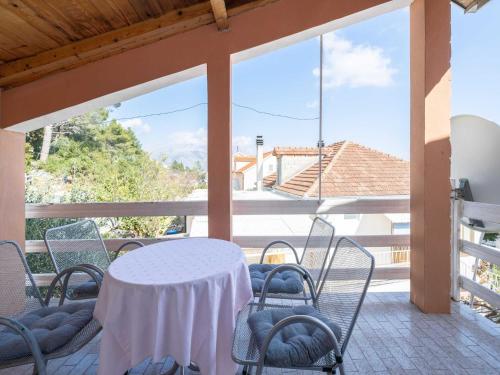 a white table and chairs on a balcony at LaidBack Apartments - Standard One Bedroom Apartment with Balcony and Sea View Azur in Orebić