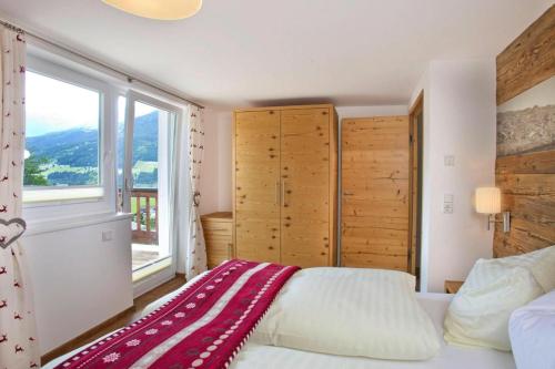 A bed or beds in a room at Apartment in Neukirchen with a balcony
