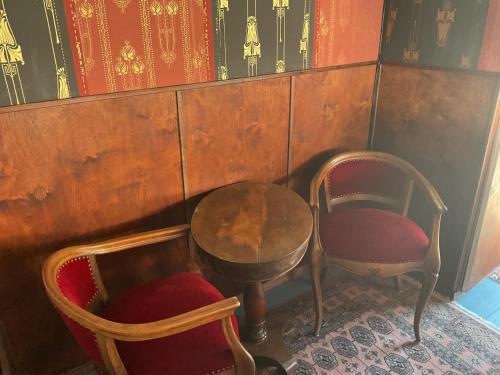 a room with two chairs and a table and a table and chairs at Grand Circus Hotel in Malmö