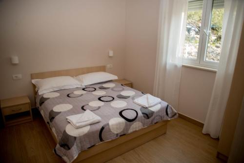 a bedroom with a bed with towels on it at Waterfront Apartments - Tucepi in Tučepi