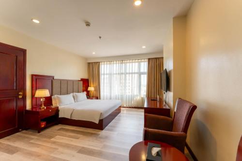 Postel nebo postele na pokoji v ubytování Swiss-Belhotel Blulane