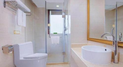 a bathroom with a toilet and a sink and a shower at Vienna 3 Best Hotel Dongguan Fenggang Yongsheng Street in Tiantangwei