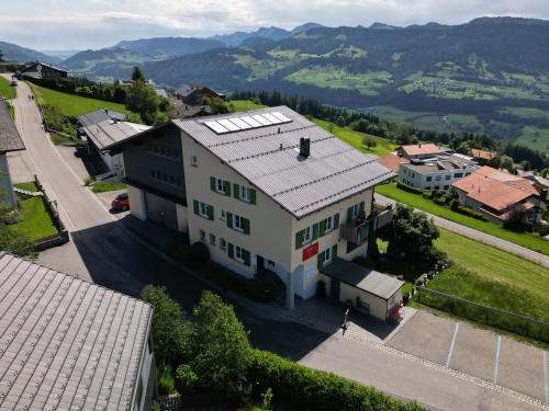 an aerial view of a white house with a roof at Frühstückspension Bilgeri in Sulzberg
