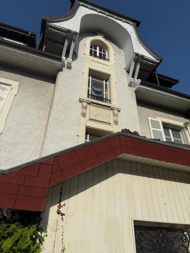 a building with a tower with a clock in a window at Villa Laura in Lausanne
