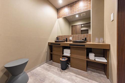 a bathroom with two sinks and a mirror at MADOKA Kyoto station west in Kyoto