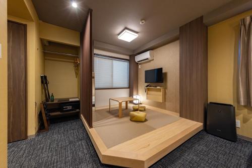 a room with a desk and a table in a room at MADOKA Kyoto station west in Kyoto