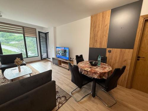 a living room with a table and a couch at Nikol5 Deluxe in Velingrad