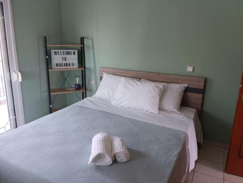 two towels sitting on a bed in a bedroom at Maisonette Mangana in Xanthi