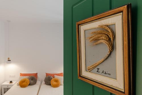 a framed picture of a feather on a wall at Birbas Hotel in Agia Anna Naxos