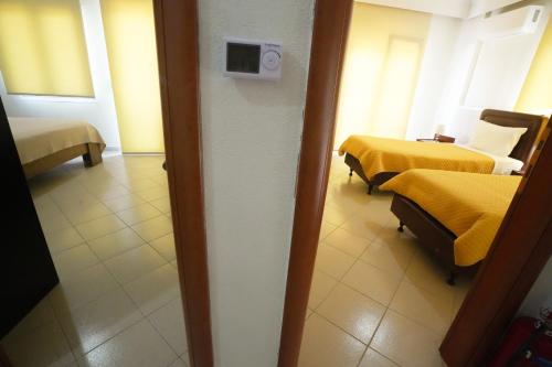 a room with two beds and a room with two beds at Διαμερίσματα Μαριάννα in Drama