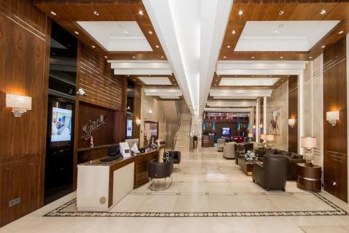 a lobby of a salon with chairs and a bar at Gems Hotel in Beirut