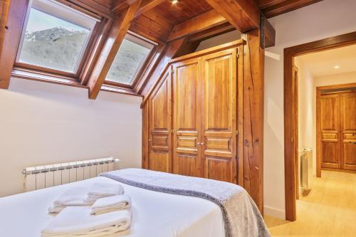 a bedroom with a bed and a wooden cabinet at Luderna - Dúplex con terraza Laveja in Gessa