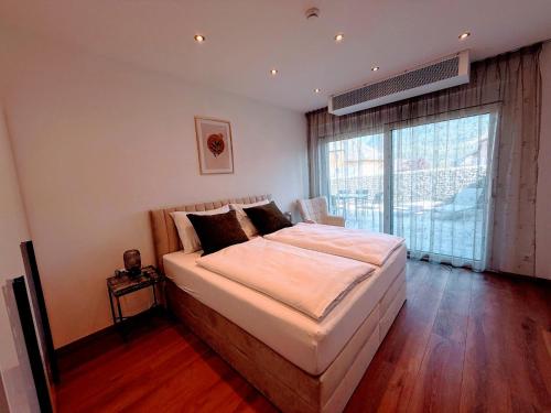 Ένα ή περισσότερα κρεβάτια σε δωμάτιο στο Ferienappartements DeLux Keutschach am See