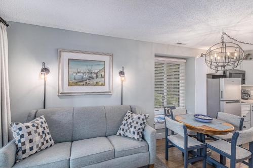 a living room with a couch and a table at Snug Lake View Condo The Shores in Traverse City