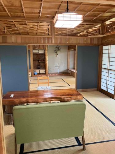 a large room with a wooden table in a room at コテージ天豆 in Yakushima