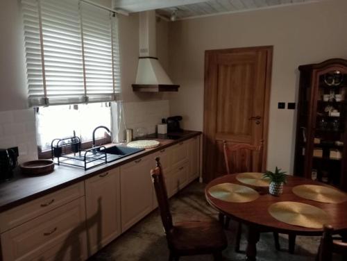 a kitchen with a table and a sink and a table and a dining room at Dom ARCHITEKTA 
