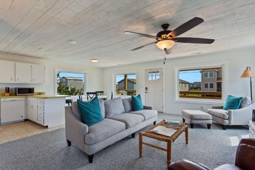 a living room with a couch and a ceiling fan at 4086 - The Wren's Nest in Kitty Hawk