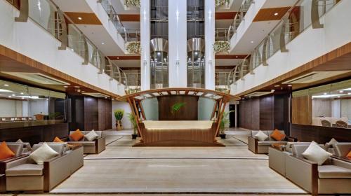 a lobby of a hotel with a couch and chairs at The Fern Residency, MIDC, Pune in Pune