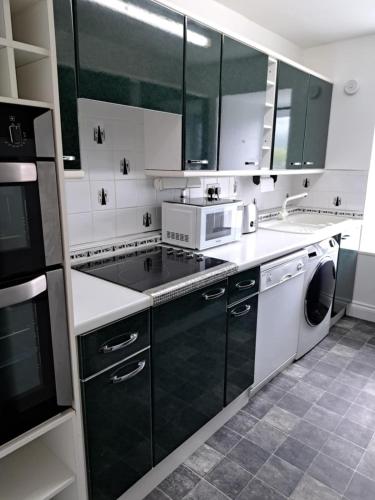 a kitchen with a sink and a stove top oven at Historic central apartment in Castlehill Mansions in Campbeltown