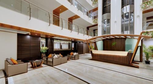 a lobby of a building with a couch and chairs at The Fern Residency, MIDC, Pune in Pune