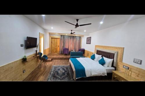 a bedroom with a bed and a living room at Lavender House in Nubra