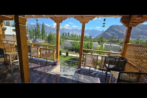 a balcony with chairs and a view of mountains at Lavender House in Nubra