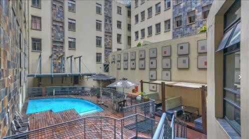 - Balcón de un edificio con vistas a la piscina en Urban City Kraal at Mapungubwe Hotel, en Johannesburgo