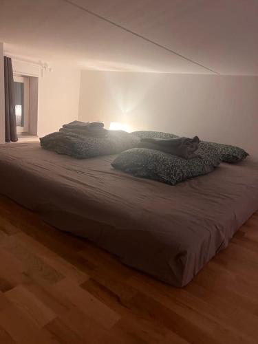 a bed with two pillows on it in a room at Beautiful Apartment with a Loft in Lomma