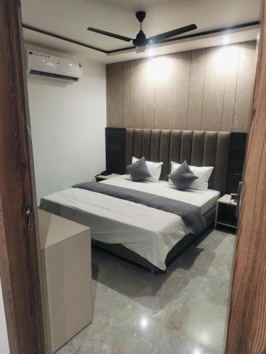 a bedroom with a large bed with a ceiling at Leipzig Hotel & Restaurant in Kurukshetra