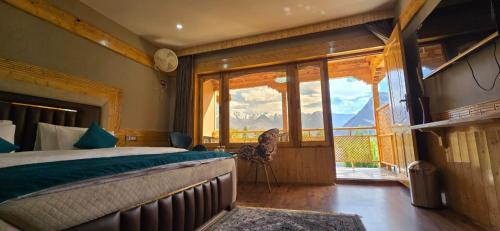 a bedroom with a bed and a view of mountains at Lavender House in Nubra