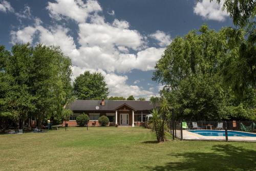 a house with a swimming pool in a yard at Quinta La Soñada in Etchegoyen