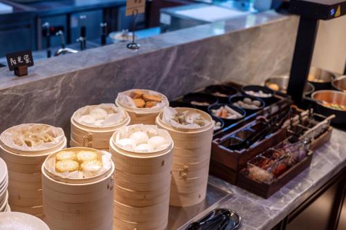 a buffet line with many different types of food at Atour Hotel Xiamen Huli Powerlong International in Xiamen