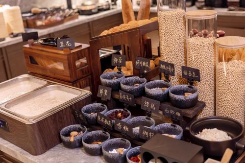 a display of rice and other food items on a counter at Atour Hotel Xiamen Huli Powerlong International in Xiamen