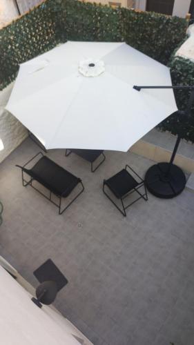 an overhead view of two chairs and an umbrella at Casa di Keti - Modern Home with Private Yard ,3 Min to the Beach in Chania