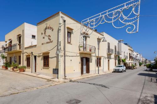 a street in a town with a building at A' Cavalera in San Vito lo Capo