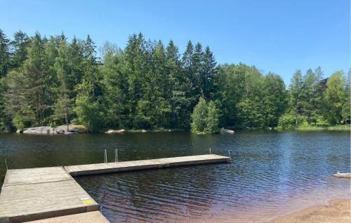 a dock in the middle of a lake at 2 Bedroom Stunning Home In Broakulla in Broakulla