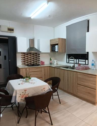 a kitchen with a table and chairs and a kitchen with a counter at Rose villa in Pereybere