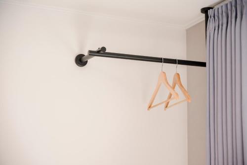 a curtain rod with two hangers in a room at Hotel Moon in Jeju
