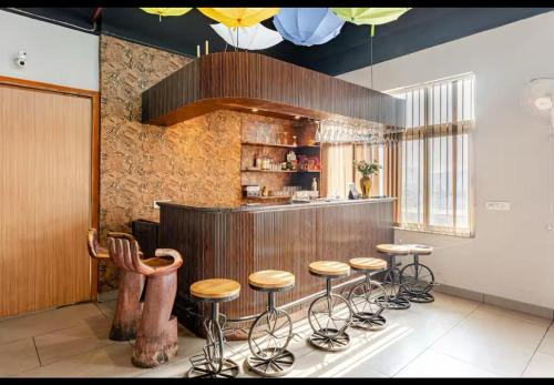 a kitchen with a bunch of stools in a room at cozy place-paramount golf forest in Greater Noida