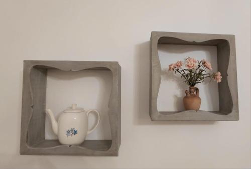 two boxes with a tea pot and a vase with flowers at Agriturismo Casa Alla Madonna in San Gimignano