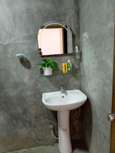 a bathroom with a sink and a mirror at Yeli gray house in Weligama