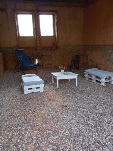 a room with two beds and a chair and a table at LES ANGES in Covelo