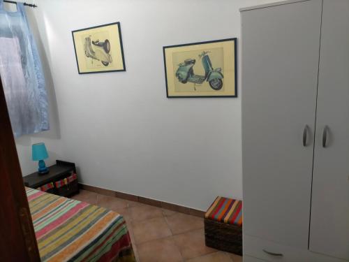 a bedroom with two pictures of animals on the wall at Il gelsomino in Manziana