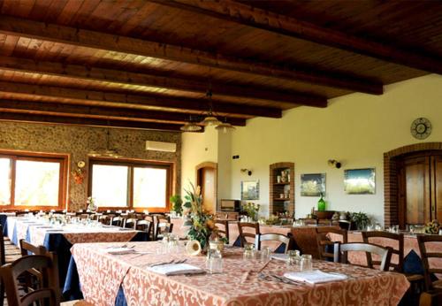 a dining room with tables and chairs in a building at Agriturismo I GELSI in Francavilla Marittima