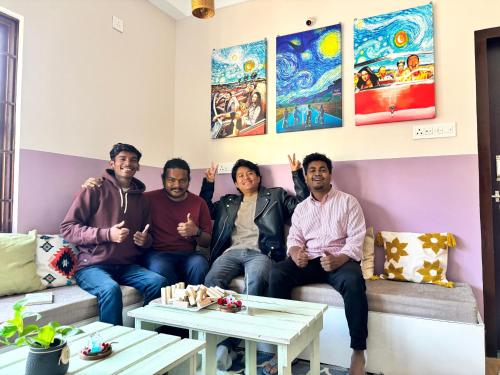 a group of people sitting on a couch in a room at Thikana by Mulaqat in Siliguri